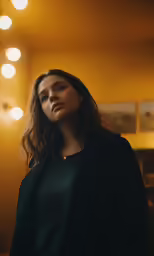 a woman with brown hair is staring into the distance