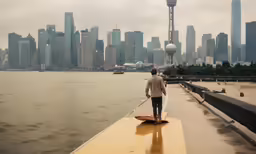 man on surfboard in front of skyline
