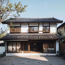 two wooden framed houses sit next to each other in the courtyard