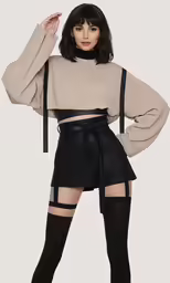 a woman posing in a high waisted skirt and thigh high socks