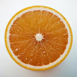 an orange is cut in half with some water inside of it