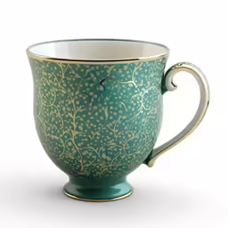 an ornate cup is sitting on a white table