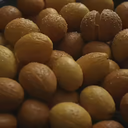 a lot of nuts covered in water droplets