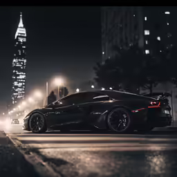a black sports car on the road in front of tall buildings
