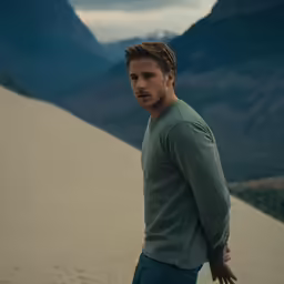 a man is standing in the sand dunes
