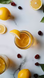 some lemons and some raspberries on top of some liquid