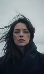 a woman with flowing wind and hair in the wind
