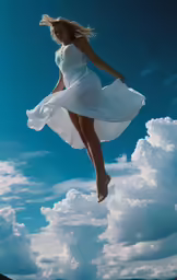 the woman is floating in the air and floating her dress on