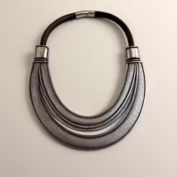 an old black necklace with several twists on it