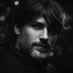 a black and white photograph of a man with a beard
