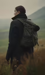 a person with a backpack looking at the horizon
