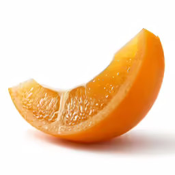 a slice of orange on a white surface
