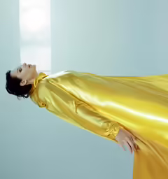 a beautiful woman wearing a shiny yellow dress