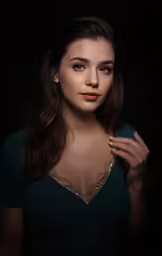 a girl in a dress poses with her hands on her hips