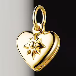 a gold heart shaped locke charm on a black and white surface,a heart with a compass on it