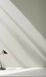 a floor lamp in the corner of a white room