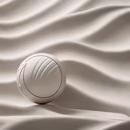 there is a white ball laying in the sand