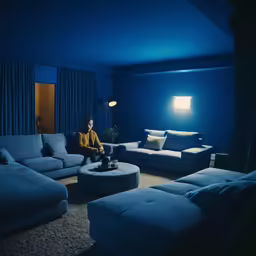 the man sits on a sofa in the living room