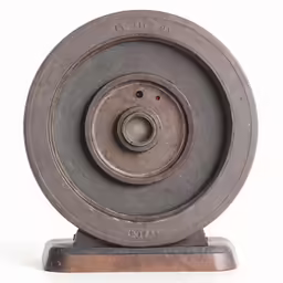 a metal spinning machine wheel on stand