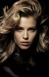 the beautiful blonde woman has her hair blowing in the wind