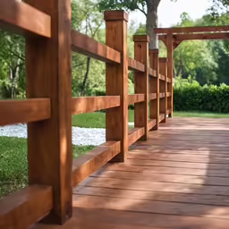 a wooden bridge extends from the grass to the water