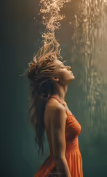 a woman is standing under the water with her hair blowing back