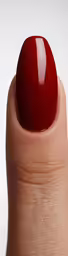 a close up of a finger with a red nail