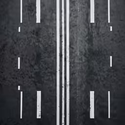 the road is black with white streaks painted on it