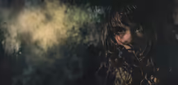 woman looking down from tree in artistic photograph