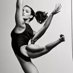 a woman in a leotard, standing on one leg