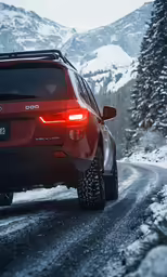 a red car driving on a snowy road