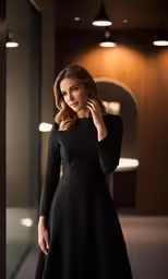 a woman standing in front of a mirror, posing for the camera