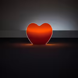 an orange heart shaped light in the dark