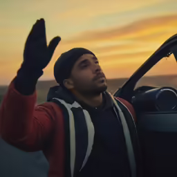 a man sitting in the passenger seat of his car