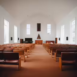 a church with brown pews and some windows