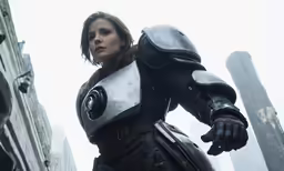 a woman dressed in armor standing in the street