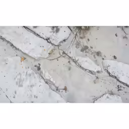 white snow is scattered over two black pieces of tile