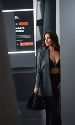 the woman is holding her purse near the wall