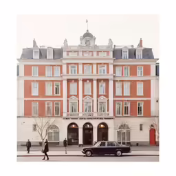 cars are parked in front of a large building