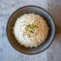 a bowl with rice and green peas is shown
