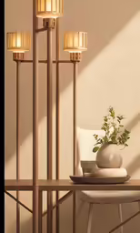 a wooden shelf with three lit candles and a vase on it