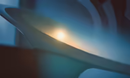 an abstract photo of the sun setting through a plastic vase
