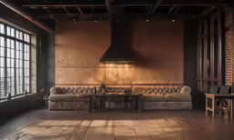 the light shines on the leather couches and tables