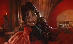 a woman in a red dress with a dark background