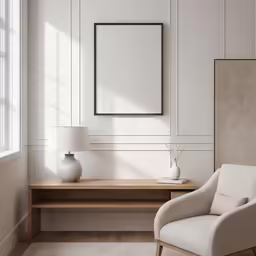 an empty chair is beside a desk and picture frame on a wall