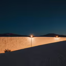 three lights on the outside wall of an apartment building