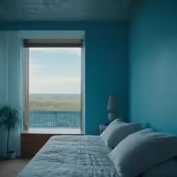 this is a blue bedroom with a window