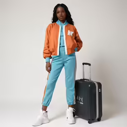 a woman with a suitcase standing next to it