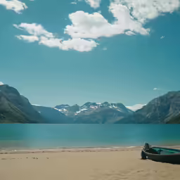 a boat is on the beach near the water