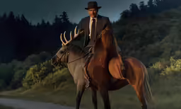 a man on a horse with another man sitting on it